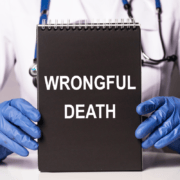 Medical professional holding a spiral notebook with wrongful death on the front