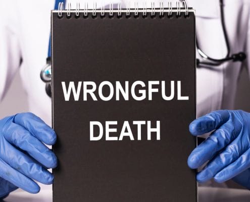 Medical professional holding a spiral notebook with wrongful death on the front