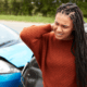 Woman holding her neck after a car accident