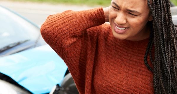 Woman holding her neck after a car accident